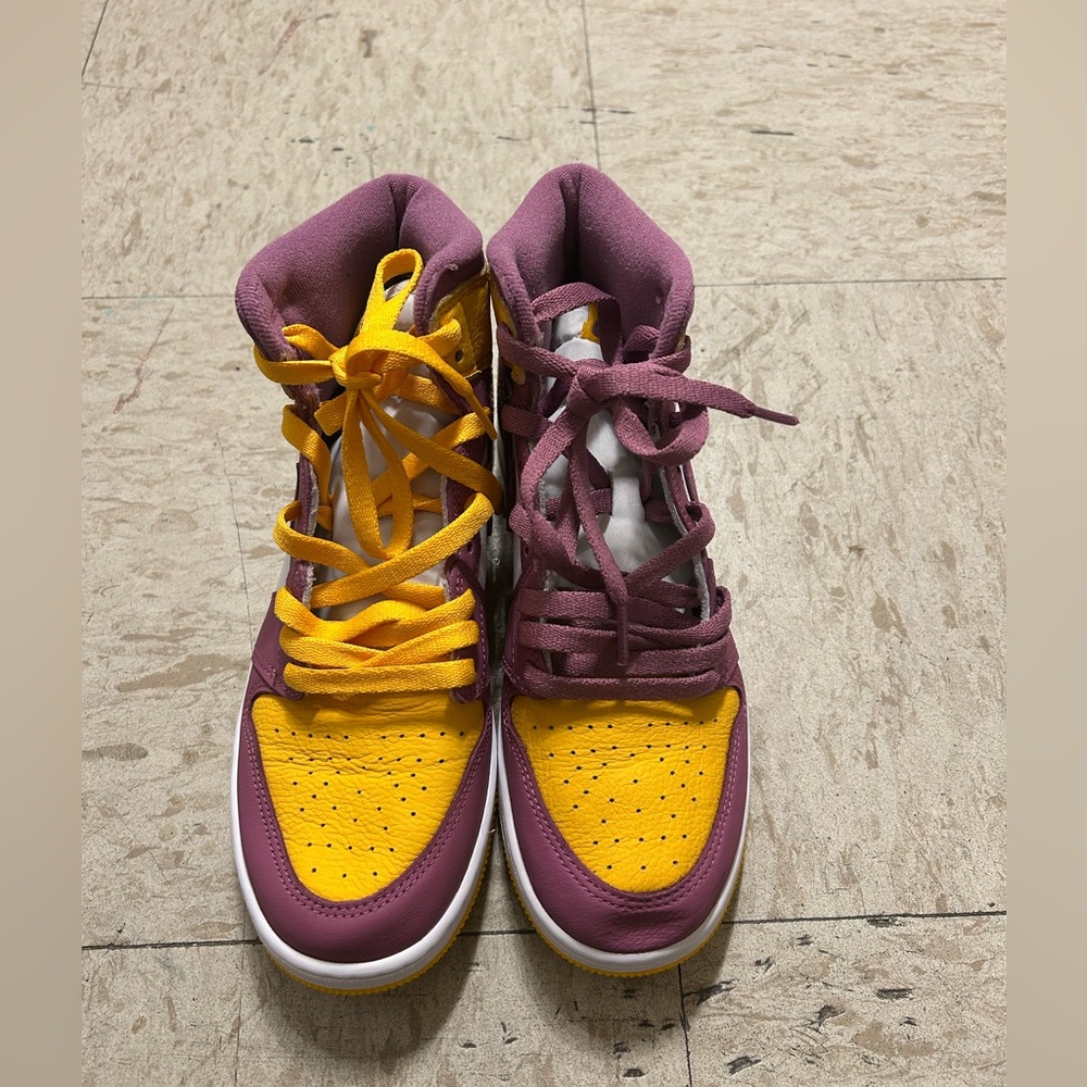 Yellow and purple high top Nike shoes
